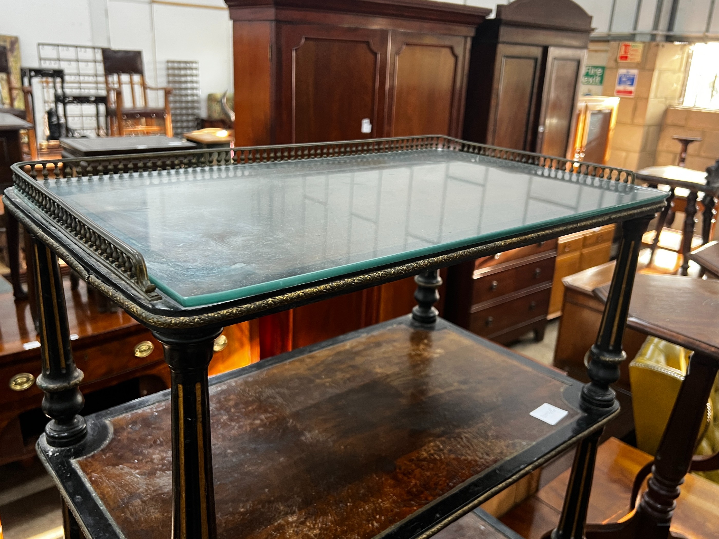 A late Victorian ebonised and amboyna three tier whatnot, width 66cm, depth 39cm, height 81cm
